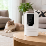 White 1080p indoor Wi-Fi security camera on a living room table with a cat in the background