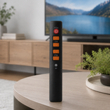 Orange-accent six-button universal learning remote on a coffee table
